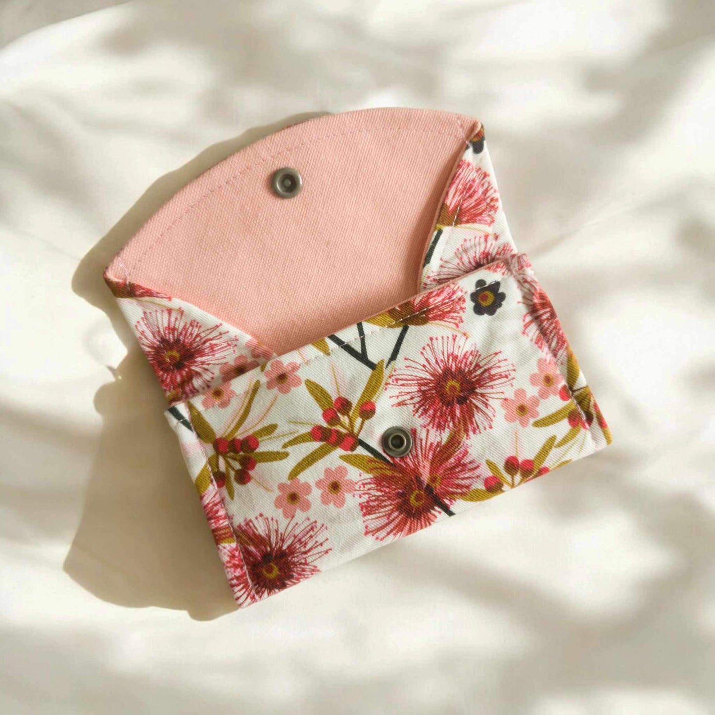 Australian floral fabric coin purse/ small glasses case open to show inside lining of purse/ case. The inside is fully lined with pink duck cloth with a layer of Decovil Light interfacing to make the purse/ glasses case sturdy.